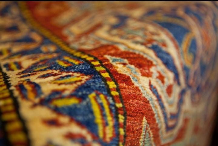 Close-up of hand-knotted Persian rug weave and texture